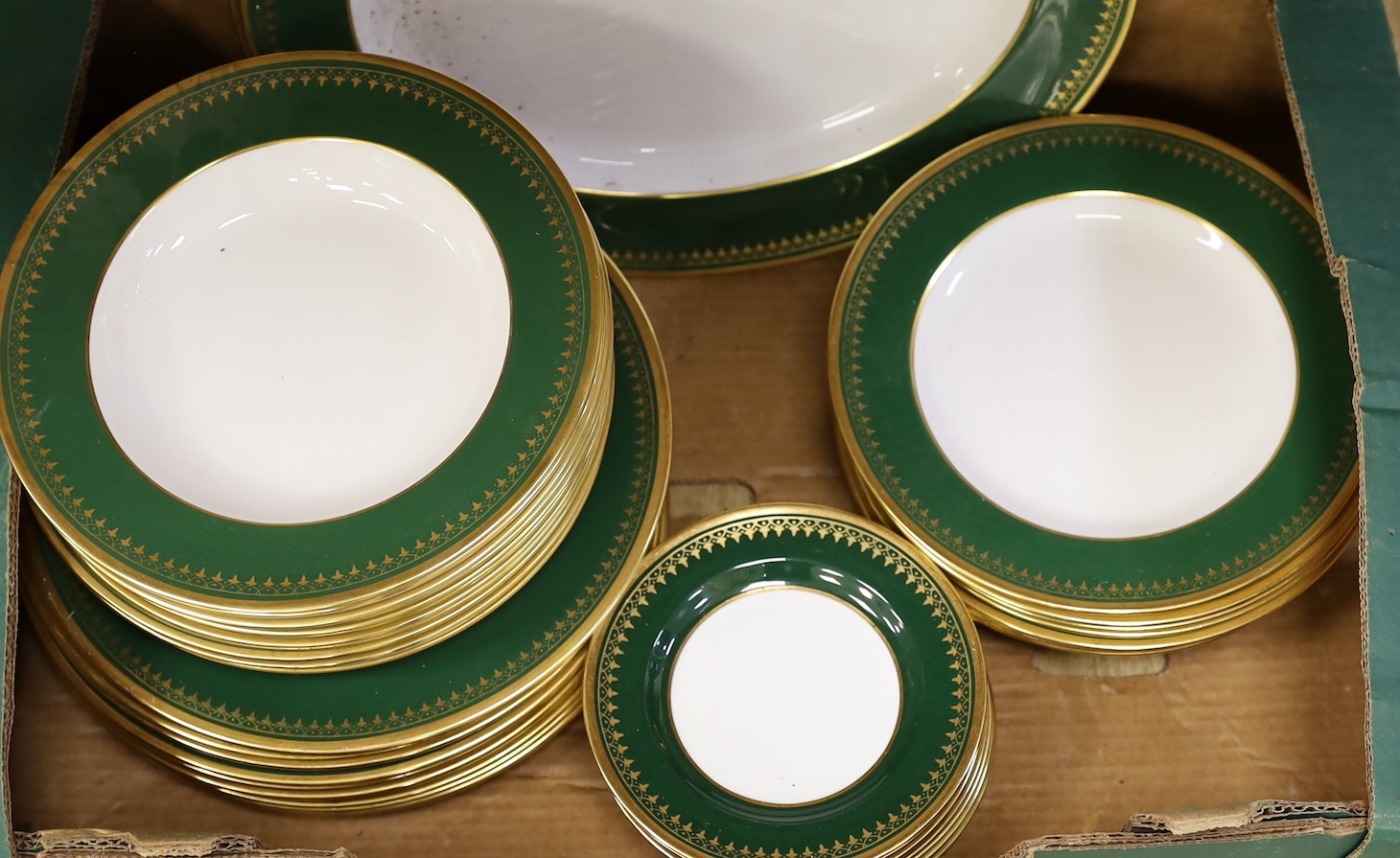 A Spode green and gold banded dinner set